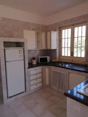 a kitchen with a white refrigerator and a microwave at Alta Marea Mondello - Palermo in Palermo
