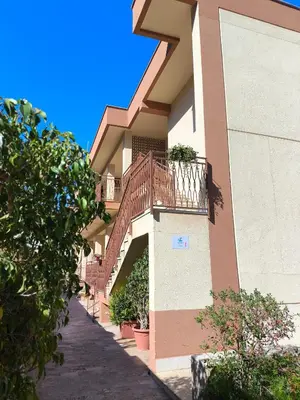 a building with a staircase on the side of it at Azzurra Apartment Mondello - Casa Vacanza a due passi dal Mare in Palermo