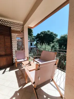 a patio with two chairs on a balcony at Azzurra Apartment Mondello - Casa Vacanza a due passi dal Mare in Palermo