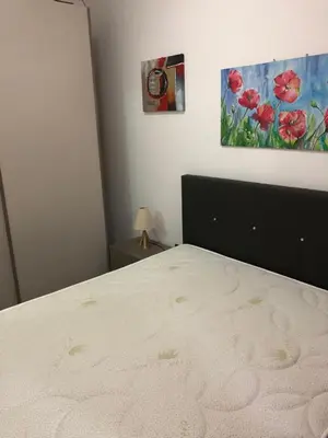 a bedroom with a bed and a painting on the wall at Villaggio 101 Pini in Buonfornello