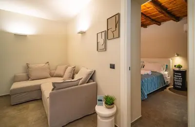 a living room with a couch and a bed at Meschita Sette in Palermo