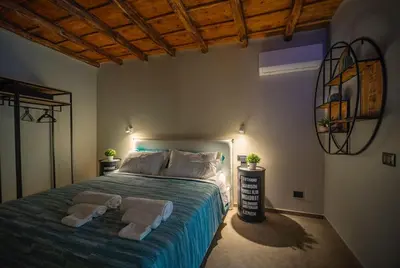 a bedroom with a bed with two towels on it at Meschita Sette in Palermo