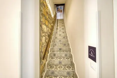 a stairway in a building with tiles on the stairs at VFH La Rada Apartments in Santa Flavia