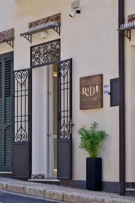 a front door of a house with a potted plant at VFH La Rada Apartments in Santa Flavia