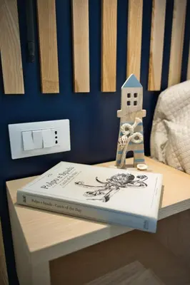 a book sitting on a table with a house on it at VFH La Rada Apartments in Santa Flavia