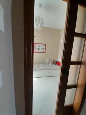 a door leading into a bedroom with a bed at La stanza del buonriposo in Palermo
