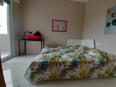a bedroom with a bed with a colorful comforter at La stanza del buonriposo in Palermo