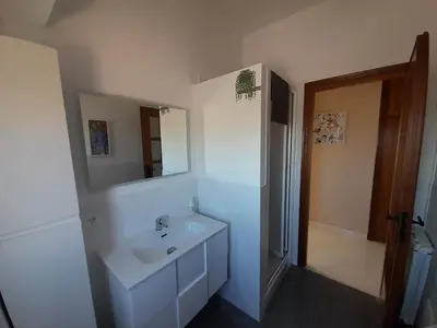 a white bathroom with a sink and a mirror at La stanza del buonriposo in Palermo