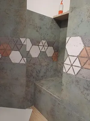 a bathroom with a shower with tiles on the wall at House Dotto 25 Apartment in Palermo