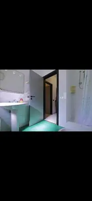 a bathroom with a sink and a tub and a mirror at Casa Pizzillo in Campofelice di Roccella