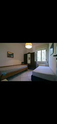 a large bedroom with two beds and a window at Casa Pizzillo in Campofelice di Roccella