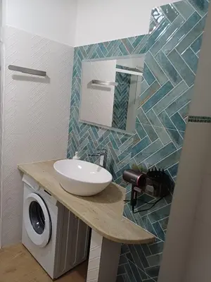 a bathroom with a sink and a mirror on a counter at Dotto 25 Apartment in Palermo