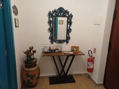 a table with a mirror on a wall at Dotto 25 Apartment in Palermo