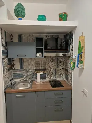 a kitchen with a sink and a counter top at Dotto 25 Apartment in Palermo