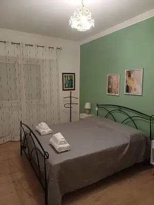 a bedroom with a bed with two towels on it at Dotto 25 Apartment in Palermo