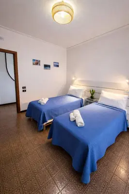 a hotel room with a bed with towels on it at Villa Aria di Mare in Carini