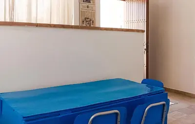 a blue table and chairs in a room at Casetta San Giovanni in Giuliana