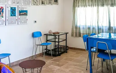 a room with blue chairs and a table at Casetta San Giovanni in Giuliana