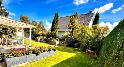 a garden with flowers and a fence at Appartamento Calabris in Bagheria