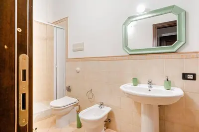 a bathroom with a sink and a toilet and a mirror at Casa Didi - Cattedrale in Palermo
