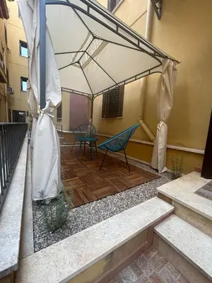 a patio with two chairs under a tent at Casa Didi - Cattedrale in Palermo