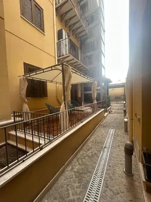a balcony of a building with an umbrella on it at Casa Didi - Cattedrale in Palermo