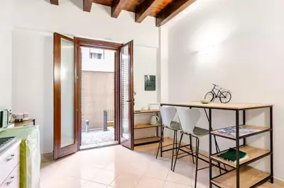 a kitchen with a counter and a table in it at Casa Didi - Cattedrale in Palermo
