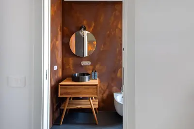 a bathroom with a sink and a mirror on a wall at Massimo Foyer 53 by Wonderful Italy in Palermo
