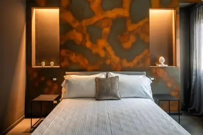 a bedroom with a large bed with two night stands at Massimo Foyer 53 by Wonderful Italy in Palermo