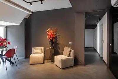 a room with two chairs and a table with a vase at Massimo Foyer 53 by Wonderful Italy in Palermo