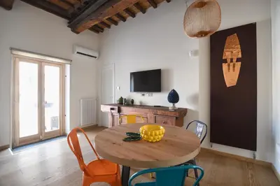 a dining room with a wooden table and chairs at iFlat Casa di Design nella piazzetta in Palermo