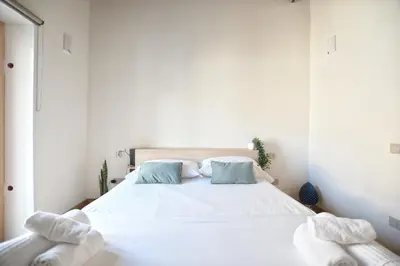 a bedroom with a white bed with towels on it at iFlat Casa di Design nella piazzetta in Palermo