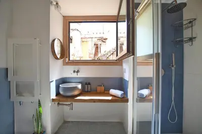 a bathroom with a sink and a window at iFlat Casa di Design nella piazzetta in Palermo