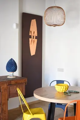 a dining room with a table and chairs at iFlat Casa di Design nella piazzetta in Palermo