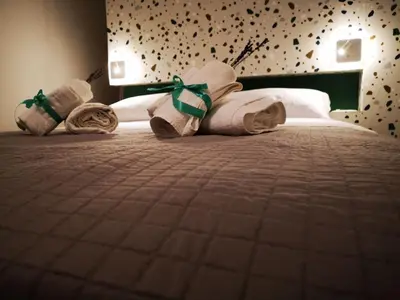a hotel room with towels on a bed at Cielo D'Alcamo Palazzo Mazzini in Alcamo