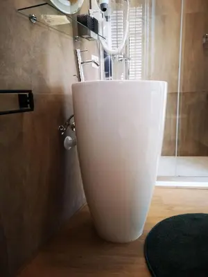 a white sink in a bathroom with a shower at Cielo D'Alcamo Palazzo Mazzini in Alcamo