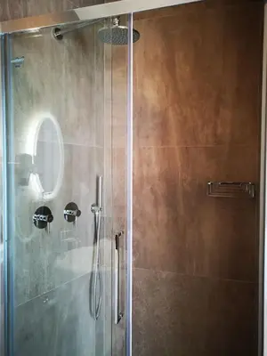 a shower with a glass door in a bathroom at Cielo D'Alcamo Palazzo Mazzini in Alcamo