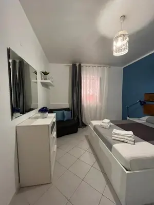 a bedroom with a bed and a couch in it at Scala Dei Normanni in Palermo