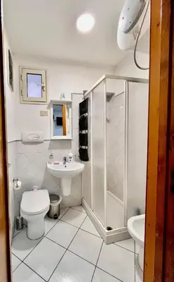 a bathroom with a toilet and a shower and a sink at Scala Dei Normanni in Palermo
