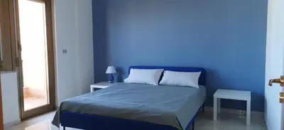 a blue bedroom with a bed with a blue wall at port side Palermo in Palermo