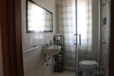 a bathroom with a sink and a toilet and a shower at port side Palermo in Palermo