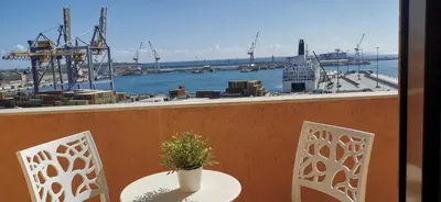 a view of a city with a mountain in the background at port side Palermo in Palermo
