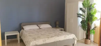a blue bedroom with a bed with a blue wall at port side Palermo in Palermo