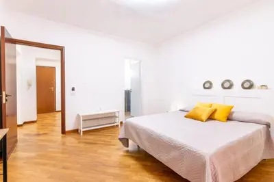 a white bedroom with a bed with yellow pillows at Balarm-Boutique Rooms in Palermo