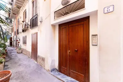 a wooden door on the side of a building at Balarm-Boutique Rooms in Palermo