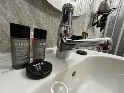 a bathroom sink with keco products sitting on it at D'Aversa Rooms in Marineo