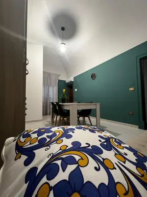 a bedroom with a bed and a table in it at D'Aversa Rooms in Marineo