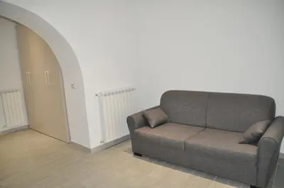 a living room with a couch and an archway at Al Bastione Holiday House in Palermo