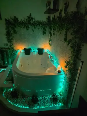 a bath tub with green lights in a bathroom at Monreale Prestige Rooms B&B in Monreale