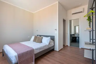 a white bedroom with a bed and a bathroom at Candelai Apartments by Wonderful Italy in Palermo